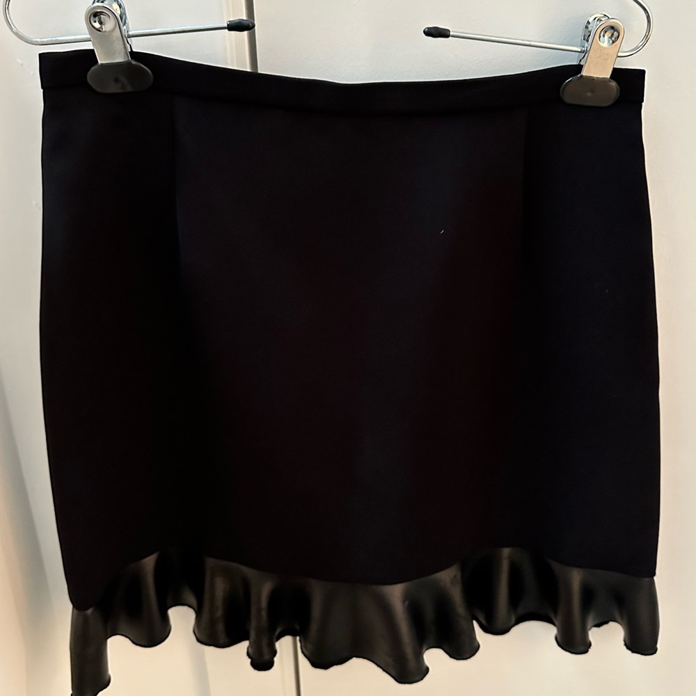 Sandro black mini skirt with faux leather trim.